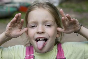 Girl of about 5 sticking out her tongue playfully