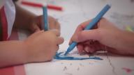 children's hands colouring in