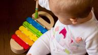 Baby playing with a xylophone