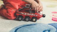 Child playing with truck toy