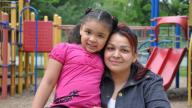 Hispanic mother and young daughter in a playground