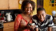 Mother and son smiling in kitchen