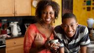 Black mum and teenage boy at home
