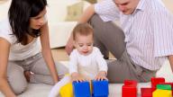 Parents with child playing with blocks