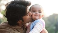 Indian dad kissing baby