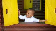 Little boy smiling in playhouse